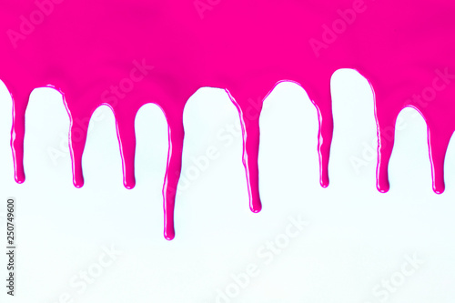 Pink paint dripping on a white.