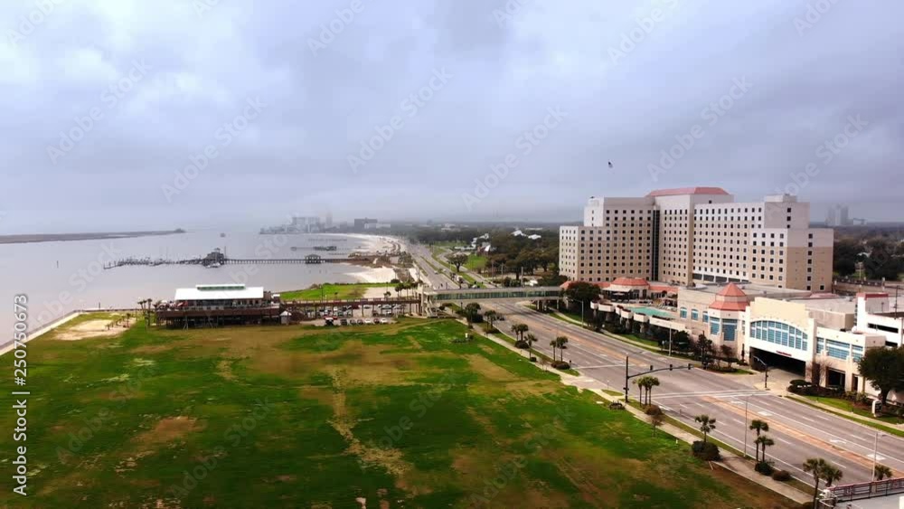 A reverse rising aerial establishing shot of the Biloxi shoreline on a foggy day. Route 90 Beach Boulevard in the foreground. A reverse rising aerial establishing shot of the Biloxi shoreline on a foggy day. Route 90 Beach Boulevard in the foreground.