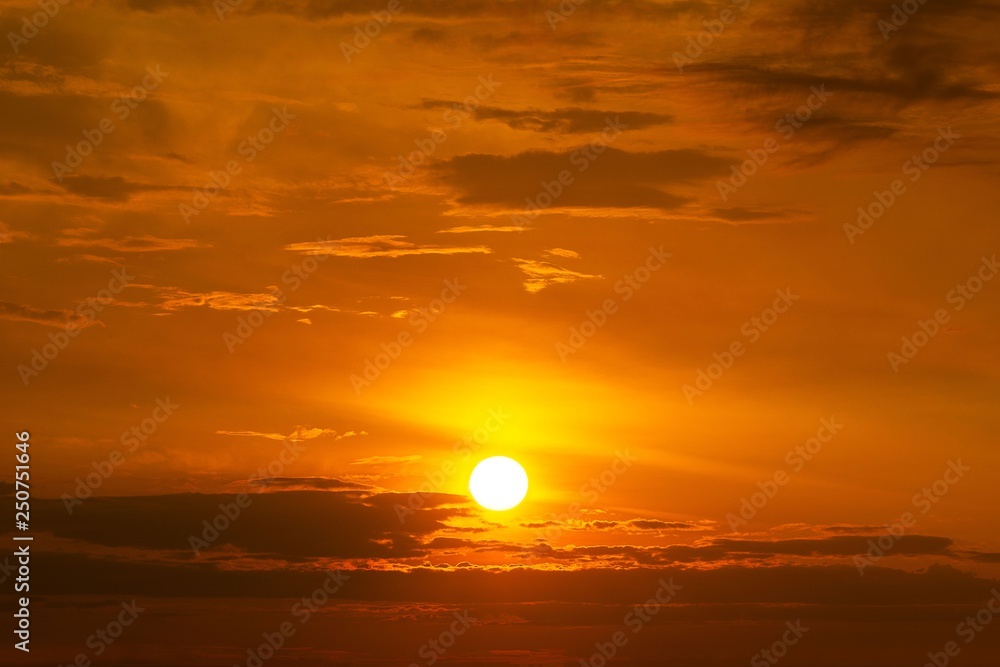 The yellow sun on the orange sky with cloud sunset background