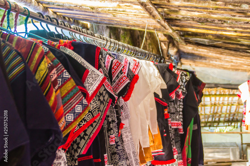Beautiful traditional handmade clothes for sale to the tourist as the souvenir at the local market in hill tribe minority village at northern Thailand.
