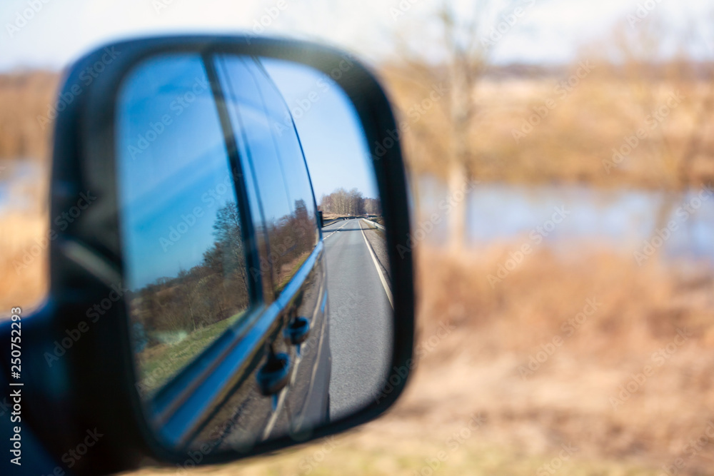 view of the road in the reflection of a side view mirror