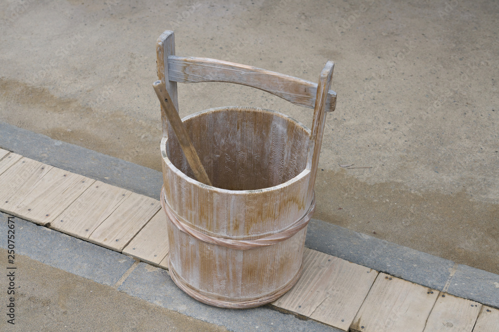 Chiba,Japan-February 19, 2019: A Japanese pail or a wooden bucket and a ladle or a dipper Chiba,Japan-February 19, 2019: A Japanese pail or a wooden bucket and a ladle or a dipper
