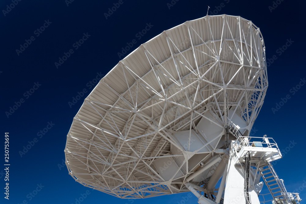 Very Large Array space, science technology huge radio satellite dish antenna pointing into a deep blue sky, horizontal aspect