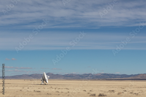 Very Large Array single radio astronomy dish alone in the desert, science technology space, horizontal aspect