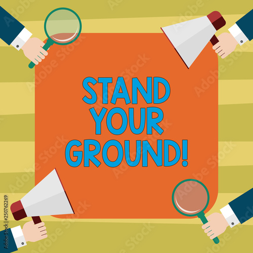 Text sign showing Stand Your Ground. Conceptual photo maintain ones position typically in face of opposition Hu analysis Hands Each Holding Magnifying Glass and Megaphone on 4 Corners photo