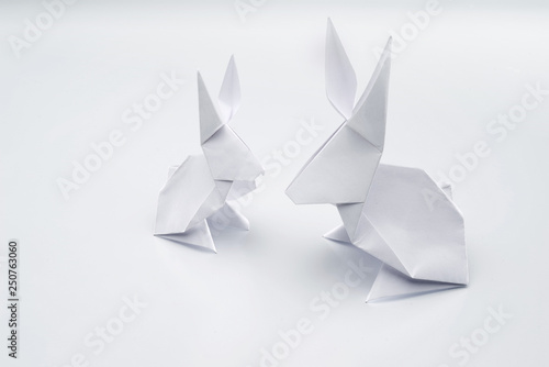 White origami rabbits on a white background.