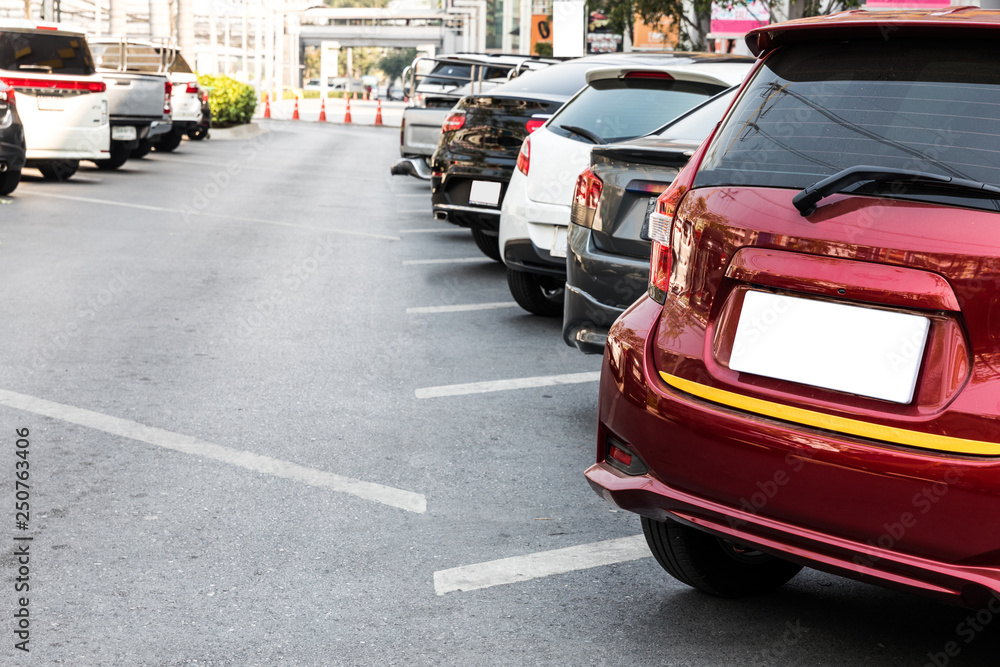 Close Up of rear or back side of car with other cars parking in parking area in the morning of sunny day. The mean of simply transportation in modern world.