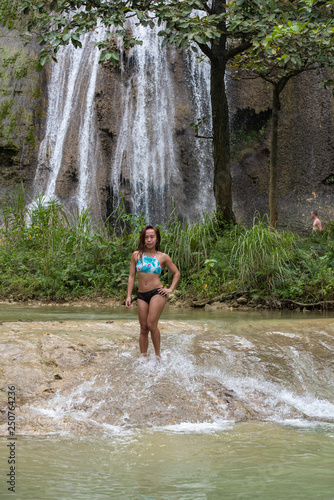 Fototapeta Naklejka Na Ścianę i Meble -  Filipino girl yoga posing at tropical waterfall 