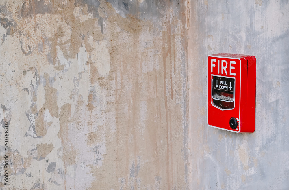fire alarm system box installed on wall in old building.