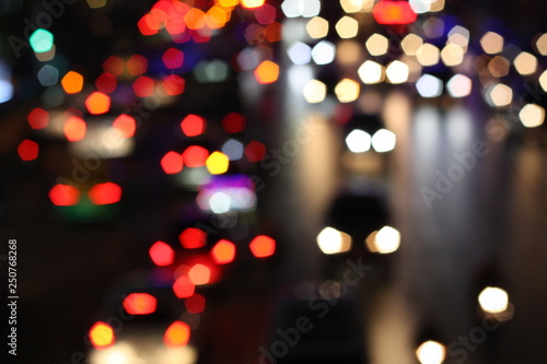 Blurred image of night life in the city. Traffic light bokeh in twilight time. © Sarocha