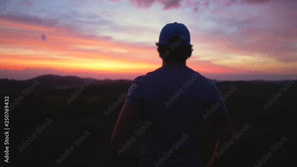 Man watching the sunrise in the mountains Man watching the sunrise in the mountains