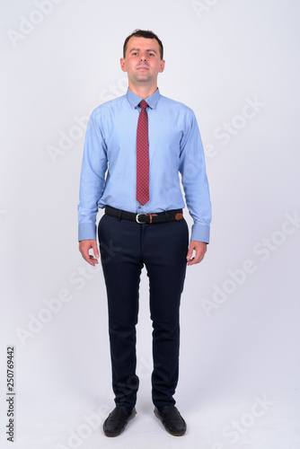 Full body shot of businessman wearing shirt and tie