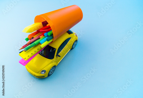 Toy car carries on the roof stationery for school.Apple