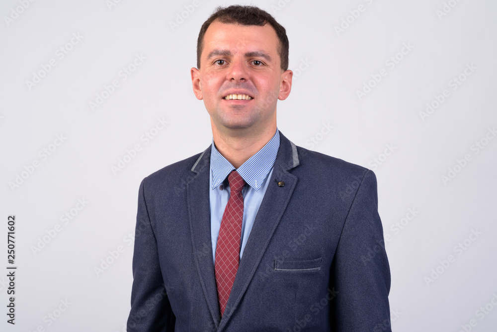 Face of happy businessman in suit smiling against white background Face of happy businessman in suit smiling against white background