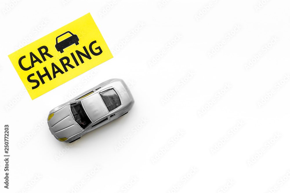 Carsharing concept. Toy car near text car sharing on white background top view space for text Carsharing concept. Toy car near text car sharing on white background top view space for text