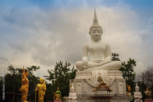 Beautiful big white buddha statue against blue sky and white cloud at the public forest temple  Wat Phu Phlan Sung  Nachaluay  Ubon Ratchathani  Thailand.