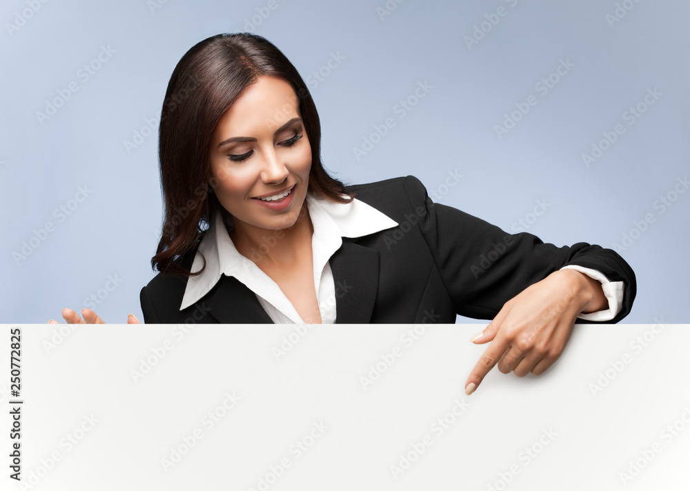 businesswoman showing blank signboard on grey businesswoman showing blank signboard on grey