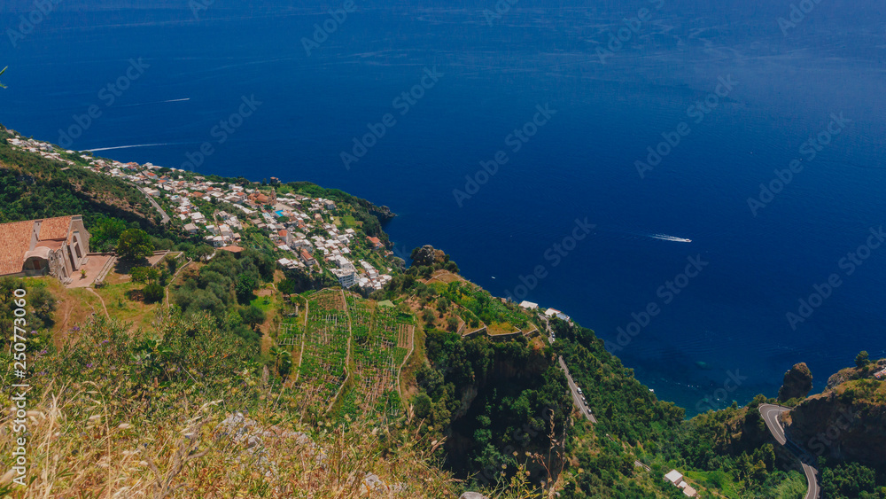 Town by blue sea and coastline of Amalfi Coast from Path of the Gods, near Positano, Italy