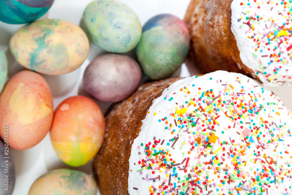 Two Easter cakes and colorful eggs on a white background Two Easter cakes and colorful eggs on a white background