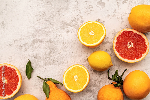 Various citrus fruits on marble background flat lay top view © dark_blade