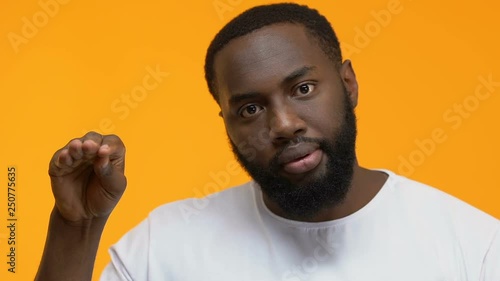 Irritated man showing bla-bla gesture, nonsense talking, gossips indifference