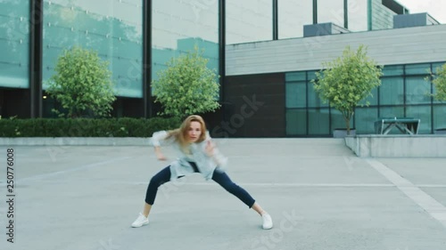 Happy Young Woman Actively Dancing on a Street