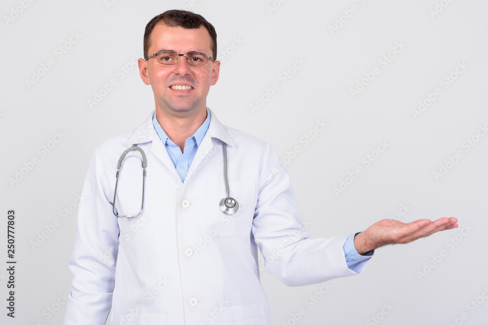 Portrait of happy man doctor with eyeglasses showing something Portrait of happy man doctor with eyeglasses showing something