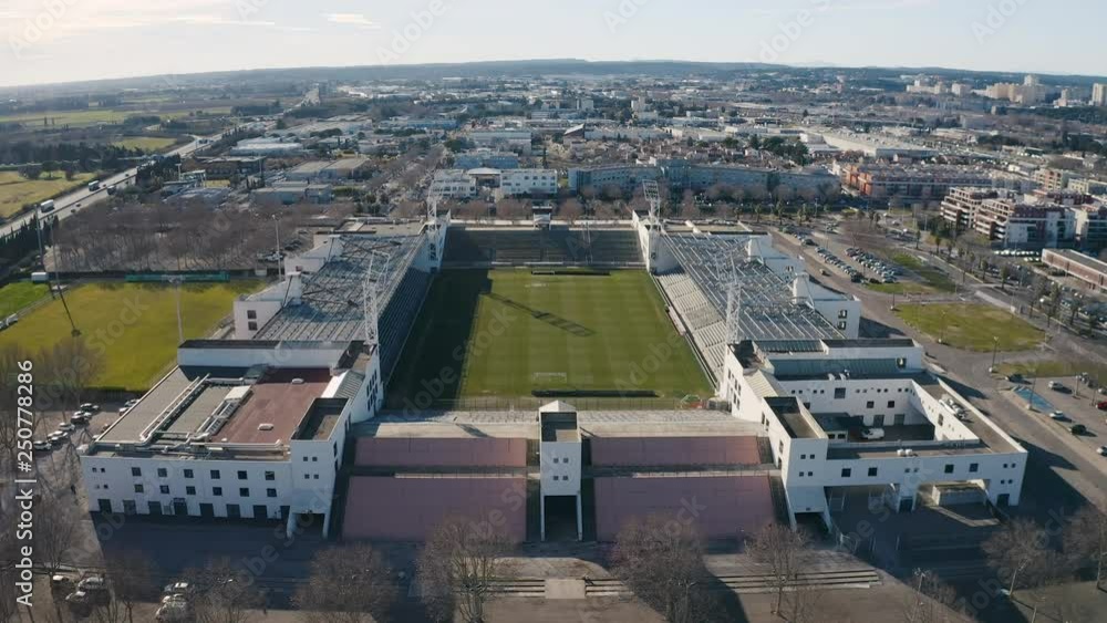Beautiful drone shot flying towards Nîmes empty football stadium France Gard Beautiful drone shot flying towards Nîmes empty football stadium France Gard