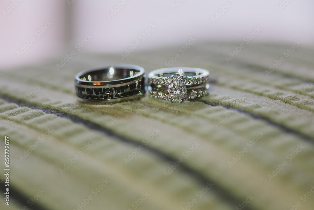 White gold wedding rings with diamonds on green pillow White gold wedding rings with diamonds on green pillow