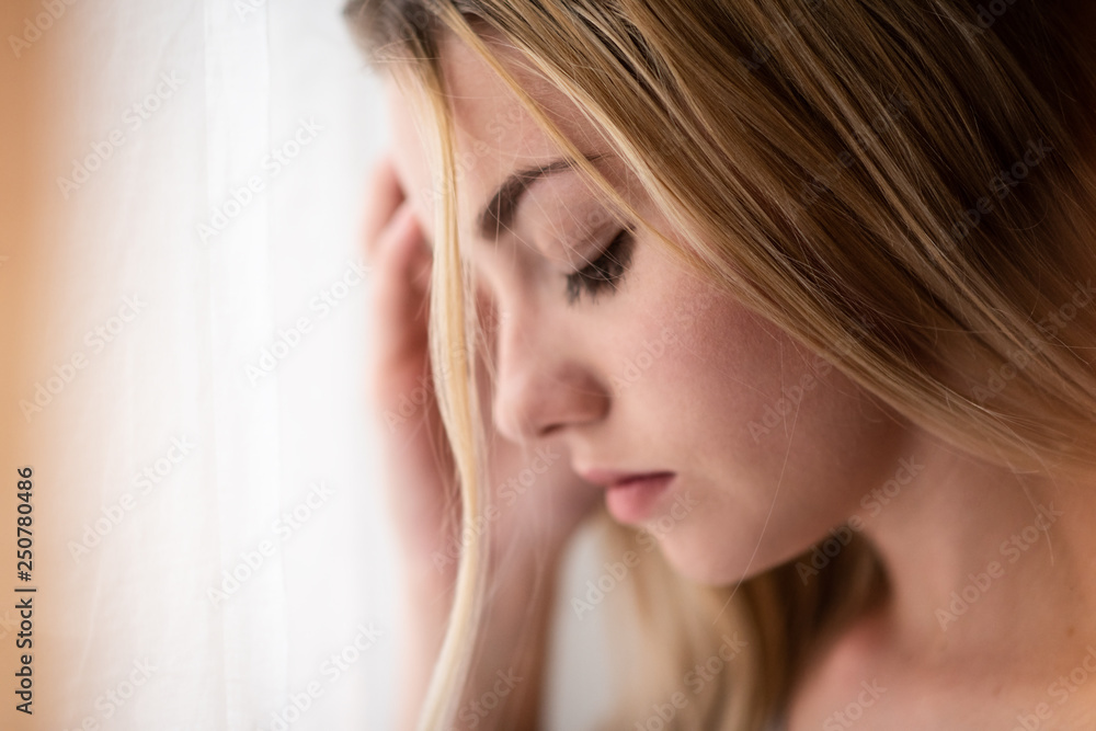 Young woman posing with eyes closed, closeup shot. Young woman posing with eyes closed, closeup shot.