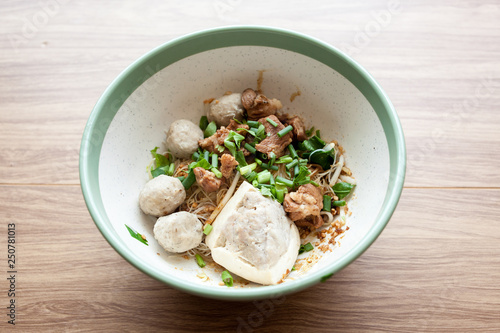 Dry noodle with pork meatball and Tofu with pork on the wood table