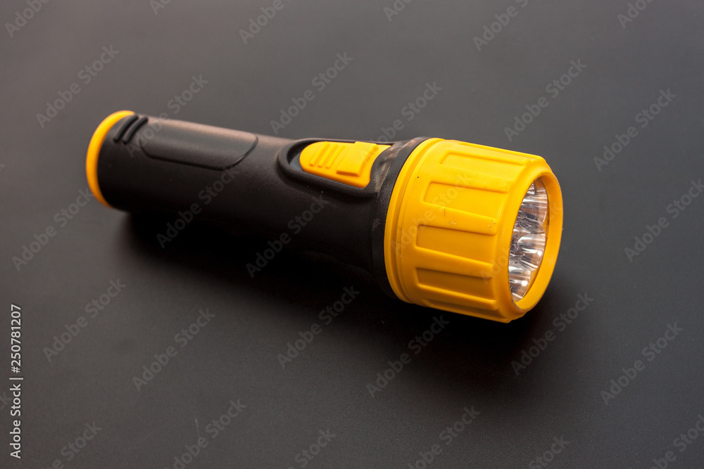 Yellow and black LED Flashlight on the black background, Emergency tool for darkness Yellow and black LED Flashlight on the black background, Emergency tool for darkness