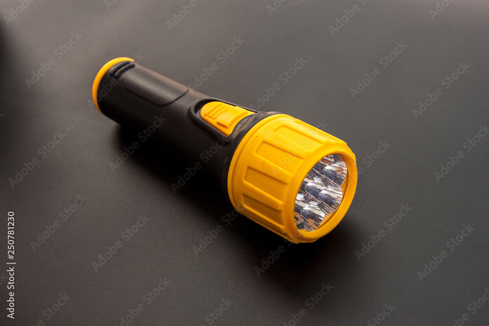 Led yellow flashlight put on black color background Led yellow flashlight put on black color background