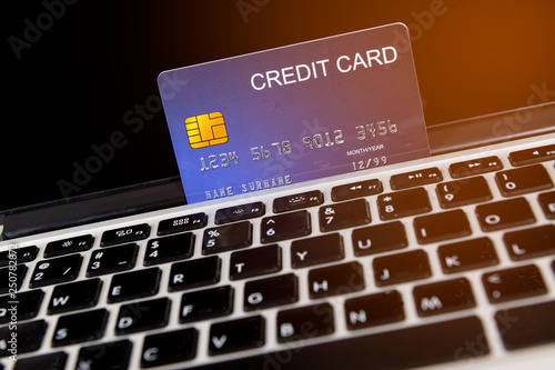 credit card place on laptop for preparing to pay with flare