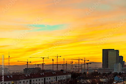 Sunset over a construction site with 16 cranes in the south of Vienna