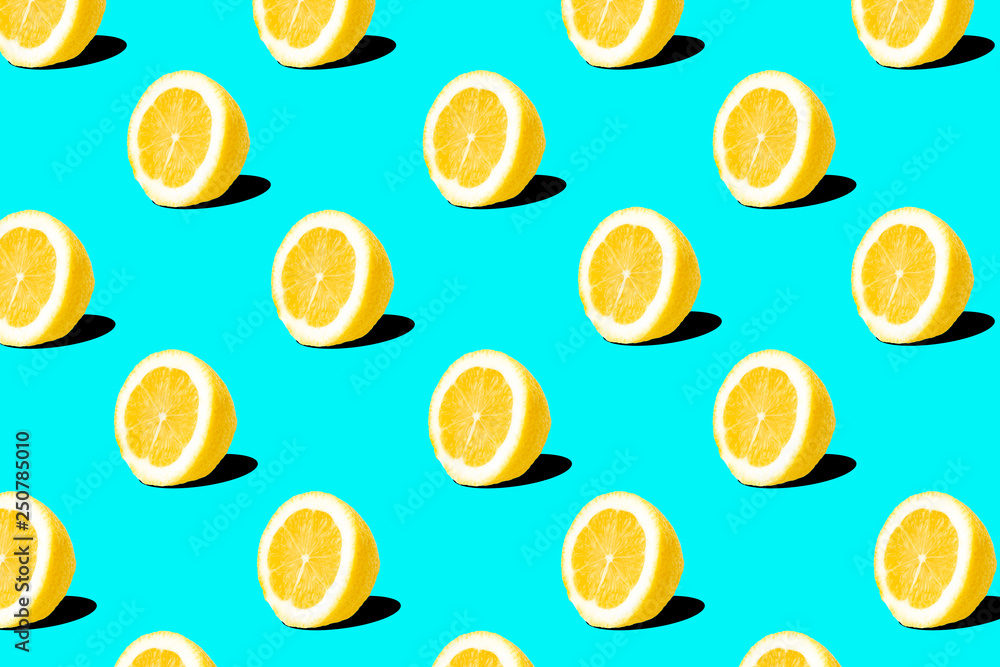 Fresh lemon (lemons) pattern on blue background. Minimal concept. Summer minimal concept. Flat lay Fresh lemon (lemons) pattern on blue background. Minimal concept. Summer minimal concept. Flat lay