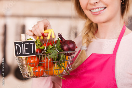 Woman holding shopping backet with vegetables