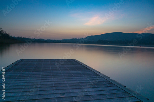 Fototapeta Naklejka Na Ścianę i Meble -  Sunset on a lake with pier