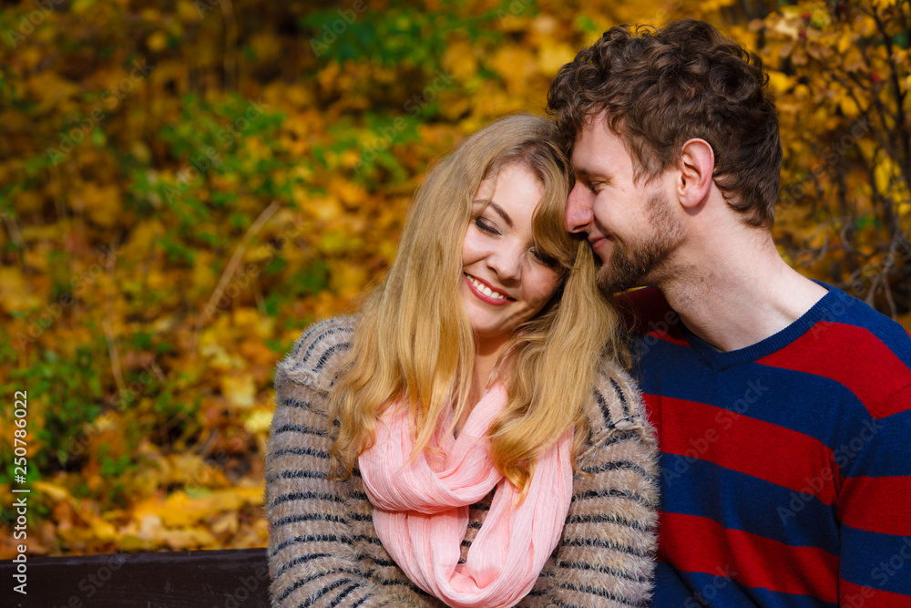 Lovers couple in autumn park on bench Lovers couple in autumn park on bench