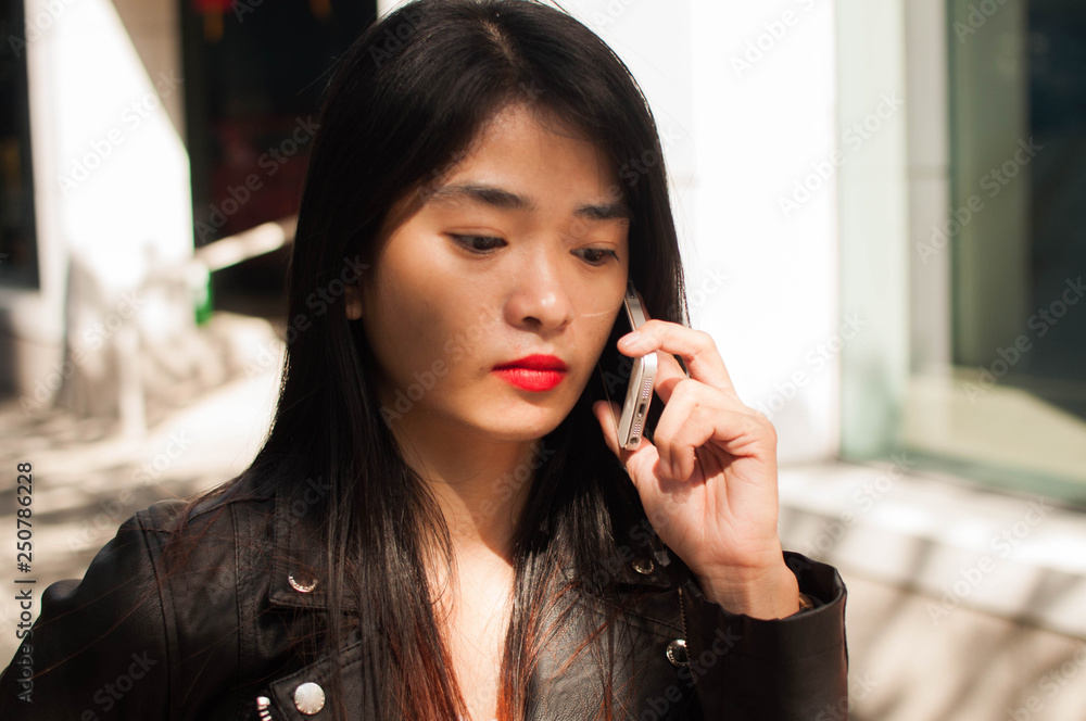 A young woman is calling from a smartphone A young woman is calling from a smartphone