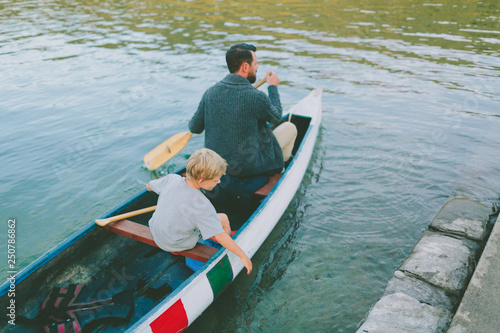 A father and son paddling a canoe