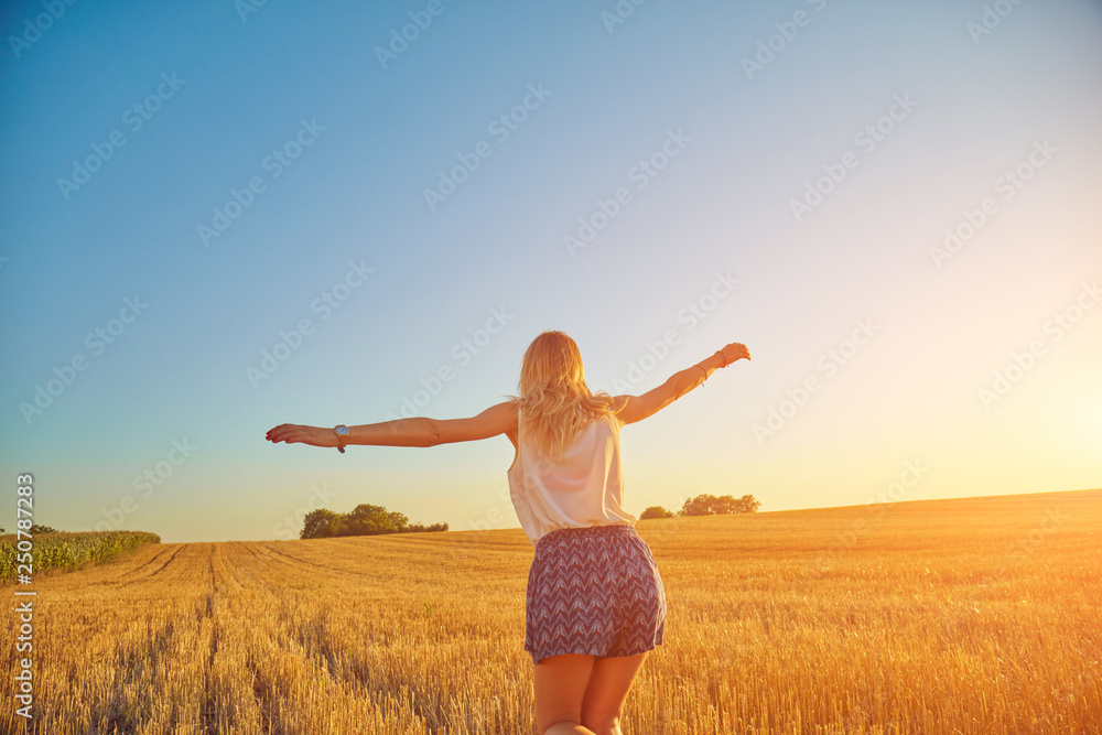 Cute young woman jumping in a wheat field. Cute young woman jumping in a wheat field.