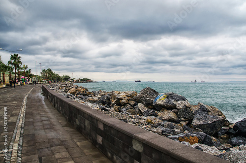 Fototapeta Naklejka Na Ścianę i Meble -  Dramatic landscape on a storm sea in Iskenderun, Turkey with stone pier