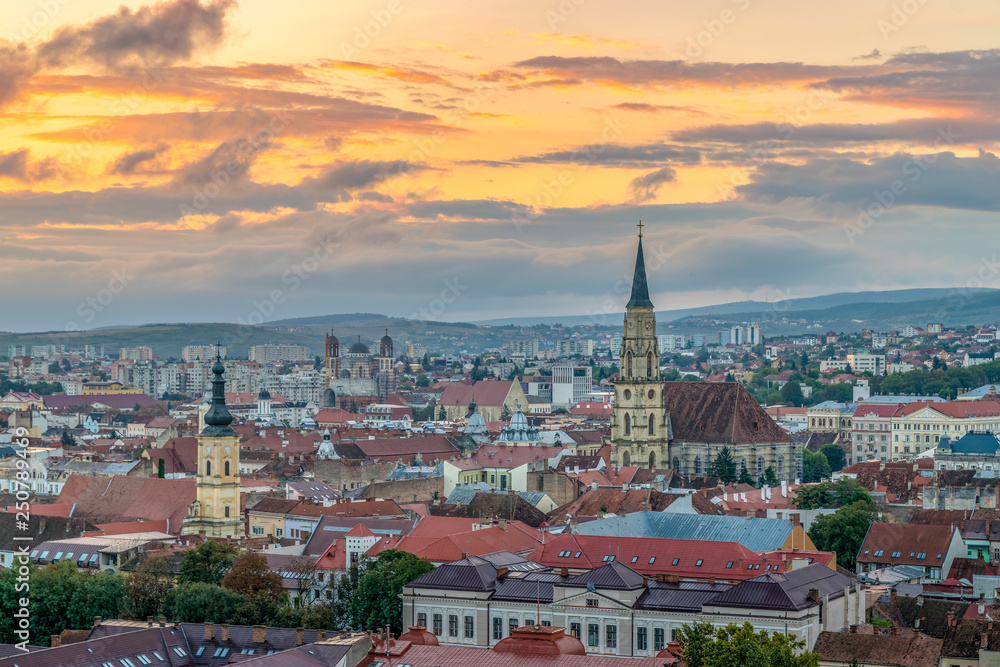 The old city of Cluj-Napoca with the Franciscan Church and St. Michael's Church viewed from Cetatuia Park at sunrise in Cluj-Napoca, Romania