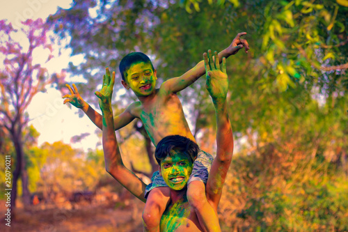 Two Indian child playing with the color in holi festival 