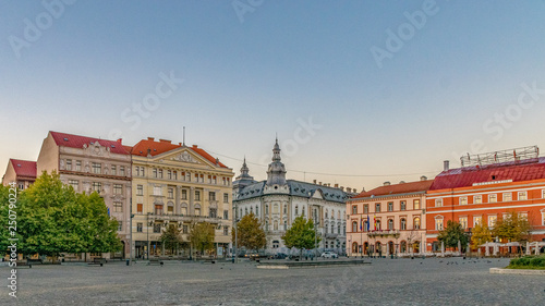 Cluj-Napoca city center. View from the Unirii Square to the Josika Palace, Rhedey Palace and New York Hotel at sunrise on a beautiful, clear sky day in Cluj Napoca, Romania