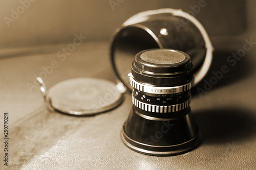 Photos Close up image of old vintage dusty lens with box on blurred background, selective focus