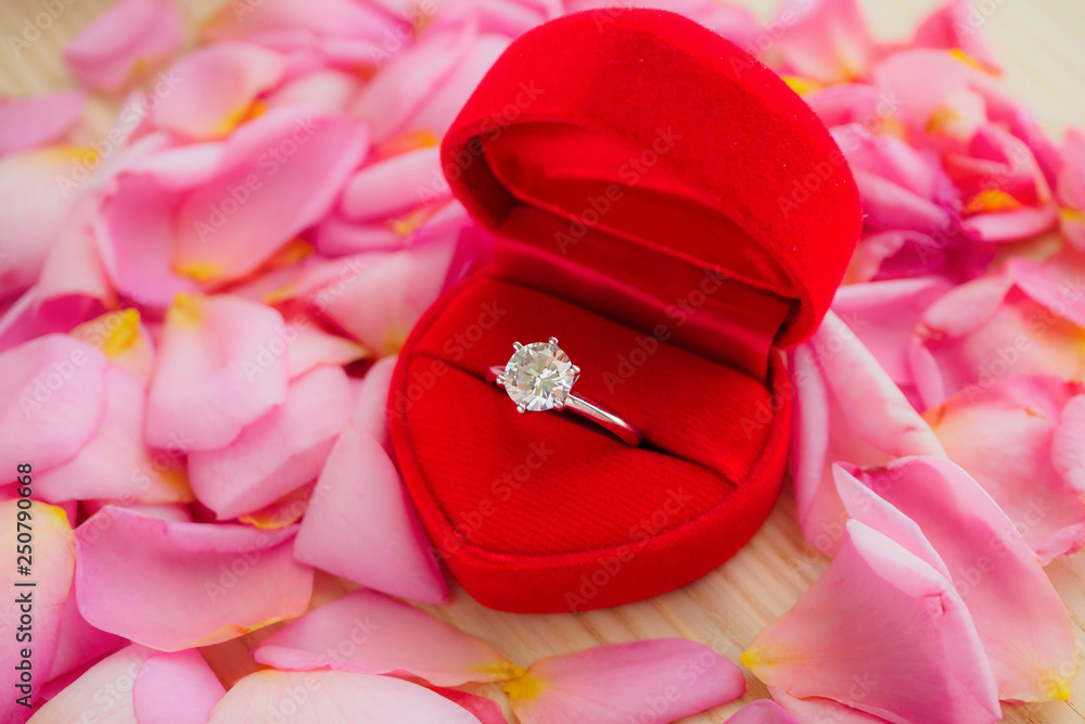 Elegant Wedding Diamond Ring In Red Heart Jewelry Box On Beautiful Pink  Rose Petal Background Close Up Stock Photo | Adobe Stock