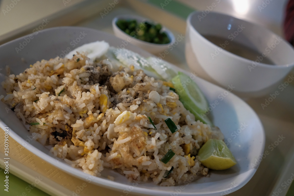 Fried rice with chicken. Prepared and served in a wok. Natural wood in the background. Top view. Fried rice with chicken. Prepared and served in a wok. Natural wood in the background. Top view.