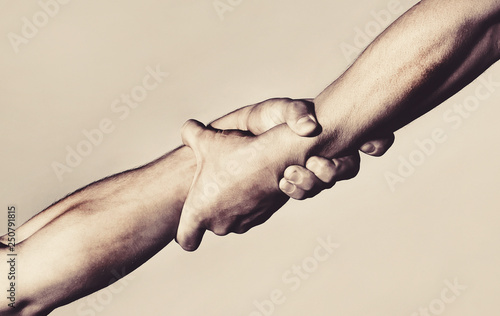 Two hands, helping hand of a friend. Handshake, arms, friendship. Friendly handshake, friends greeting, teamwork, friendship. Rescue, helping gesture or hands. Strong hold. Close-up. Black and white photo